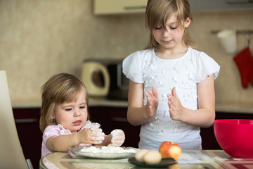 two children in the kitchen, child 2 years, child 7 years