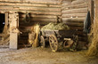 Wooden cart with hay in old barn.