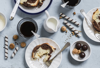 Coffee, cookies, candy, cake, cream - breakfast or snack table - on a blue stone  background