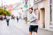 © Halfpoint - Young hipster man running in town, main street