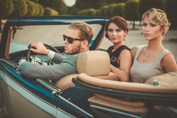 Wall Mural - Wealthy friends in a classic convertible