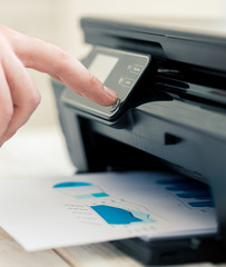 Man's hand making copies. Working with printer