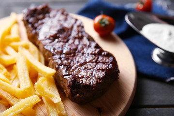 Sticker - Grilled steak with french fries, salt and cherry tomatoes, closeup