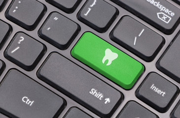 Aufkleber - Computer keyboard closeup with tooth icon on green enter key