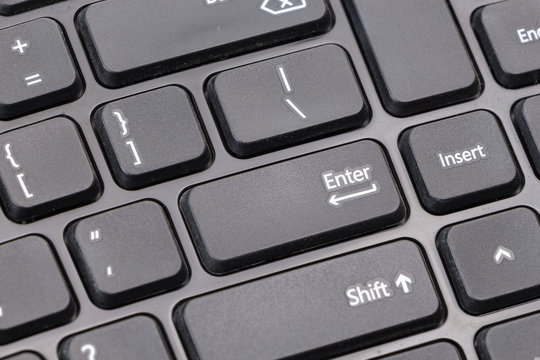 Black computer keyboard closeup on Enter