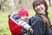 Smiling Woman With Baby In Baby Carrier