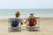 © Johnér - Smiling couple on lounge chairs