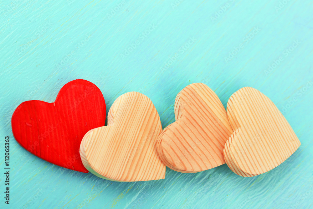 Wooden hearts on color wooden background