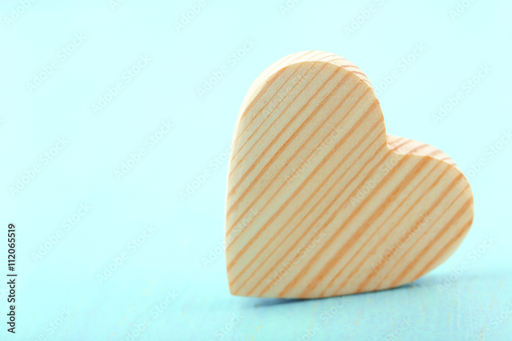 Wooden heart on color wooden background