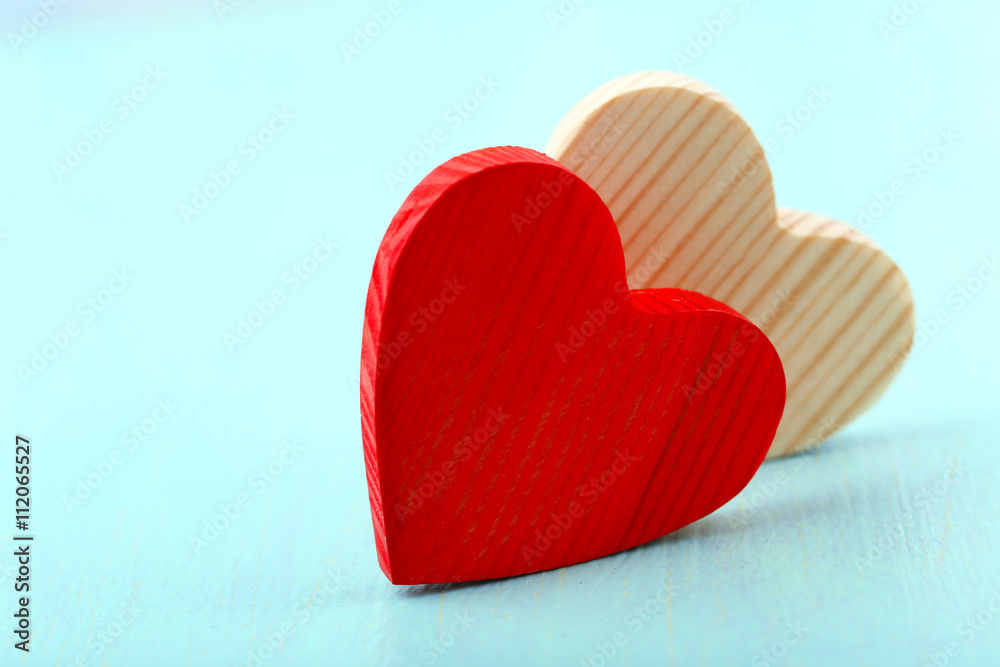 Wooden hearts on color wooden background