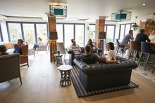 Busy Reception Area Of Modern Boutique Hotel With Guests