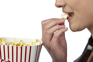 teenage girl eating popcorn