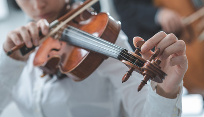 Violinist tuning a violin