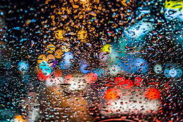 drops of rain on window with bokeh lights