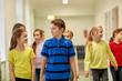 © Syda Productions - group of smiling school kids walking in corridor