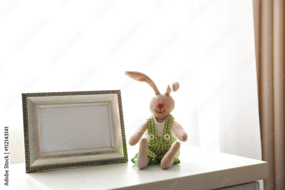 Child toy with frame on white wooden table