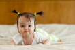 © Michael Pettigrew - Baby tummy time with funny facial expression