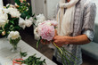 © ruslan_shramko - Male florist preparing bouquet of peones