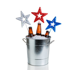 Wall Mural - Holiday stars and bucket of ice and cold beer on white 