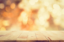Wood Table Top On Abstract Shiny Bokeh Gold Background