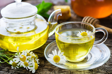 Wall Mural - Chamomile tea on wooden background