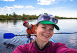 © lkoimages - Young woman doing selfie on kayak in beautiful nature. Summer sunny day