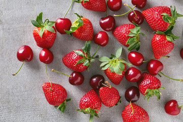 Wall Mural - Cherry and strawberry on stone table, from above