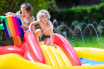 Wall Mural - Kids playing in inflatable pool