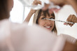 © JGI/Jamie Grill/Blend Images - Mixed race woman trimming her bangs