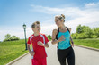 © Louis-Photo - Family, mother and son are running or jogging for sport outdoors