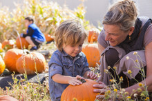 Caucasian Mother And Son In Pumpkin Patch