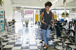 © Peathegee Inc/Blend Images - Mixed race hairstylist smiling in salon