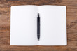 © sripfoto - Blank note pad with pen on wood background