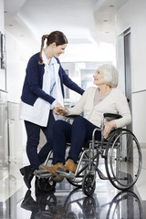 Canvas Print - Physiotherapist Consoling Senior Patient In Wheelchair