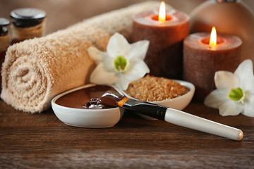 Wall Mural - Spa chocolate set with candles on blurred background