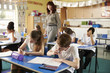 © Monkey Business - Teacher walking in her busy primary school classroom
