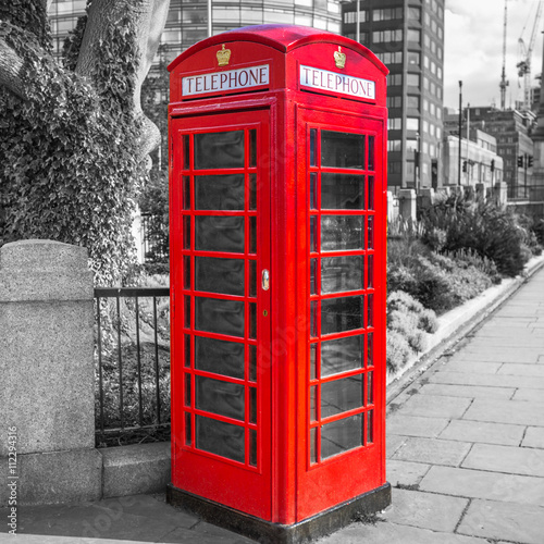 Fototapeta na wymiar Red telephone booth on the street of London, UK