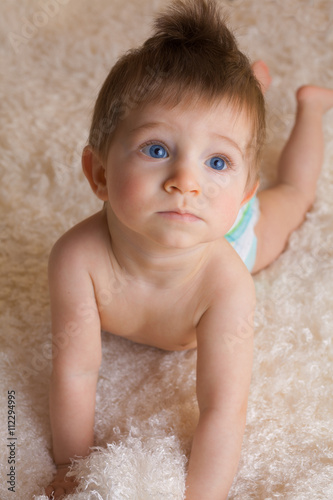 Portrait Of A One Year Old Boy With Blue Eyes And Blonde Hair