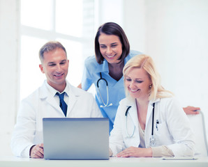 Wall Mural - group of doctors looking at tablet pc