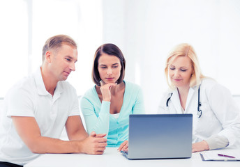 Wall Mural - doctor with patients looking at laptop