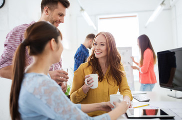 Canvas Print - happy creative team drinking coffee at office