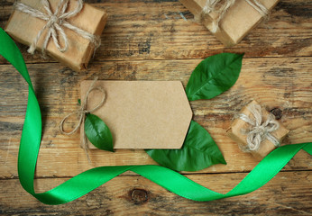 Wall Mural - simple three gift boxes with green leaves, silk ribbon