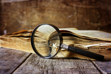 Magnifying Glass And Old Book