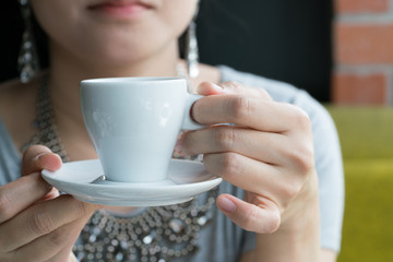  Young woman having coffee break
