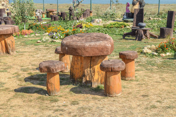 Table and chair in the shape of mushrooms. Outdoor wood furniture.