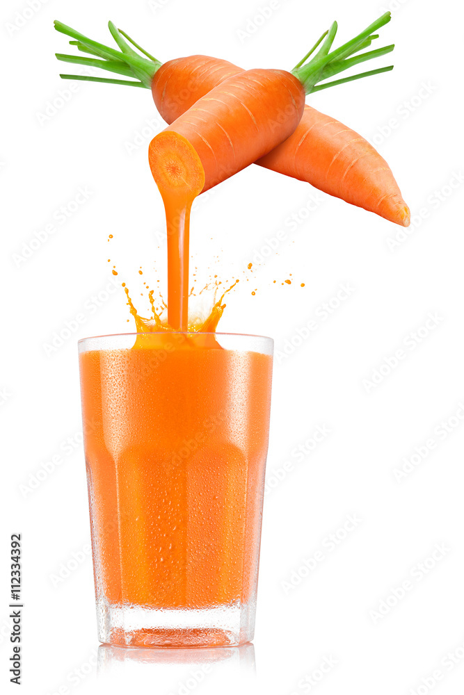 Pure carrot juice pouring out from fruit in glass - obrazy, fototapety, plakaty 