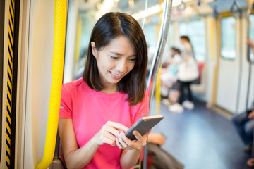 Canvas Print - Asian Woman use of mobile phone inside train