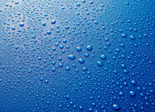 Water Drops Beaded On Blue Metallic Surface