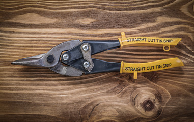 Steel cutter on vintage wooden board top view construction conce