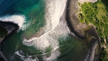 Aerial Looking At Colorful Waves Breaking On A Molokai, Hawaii Beach